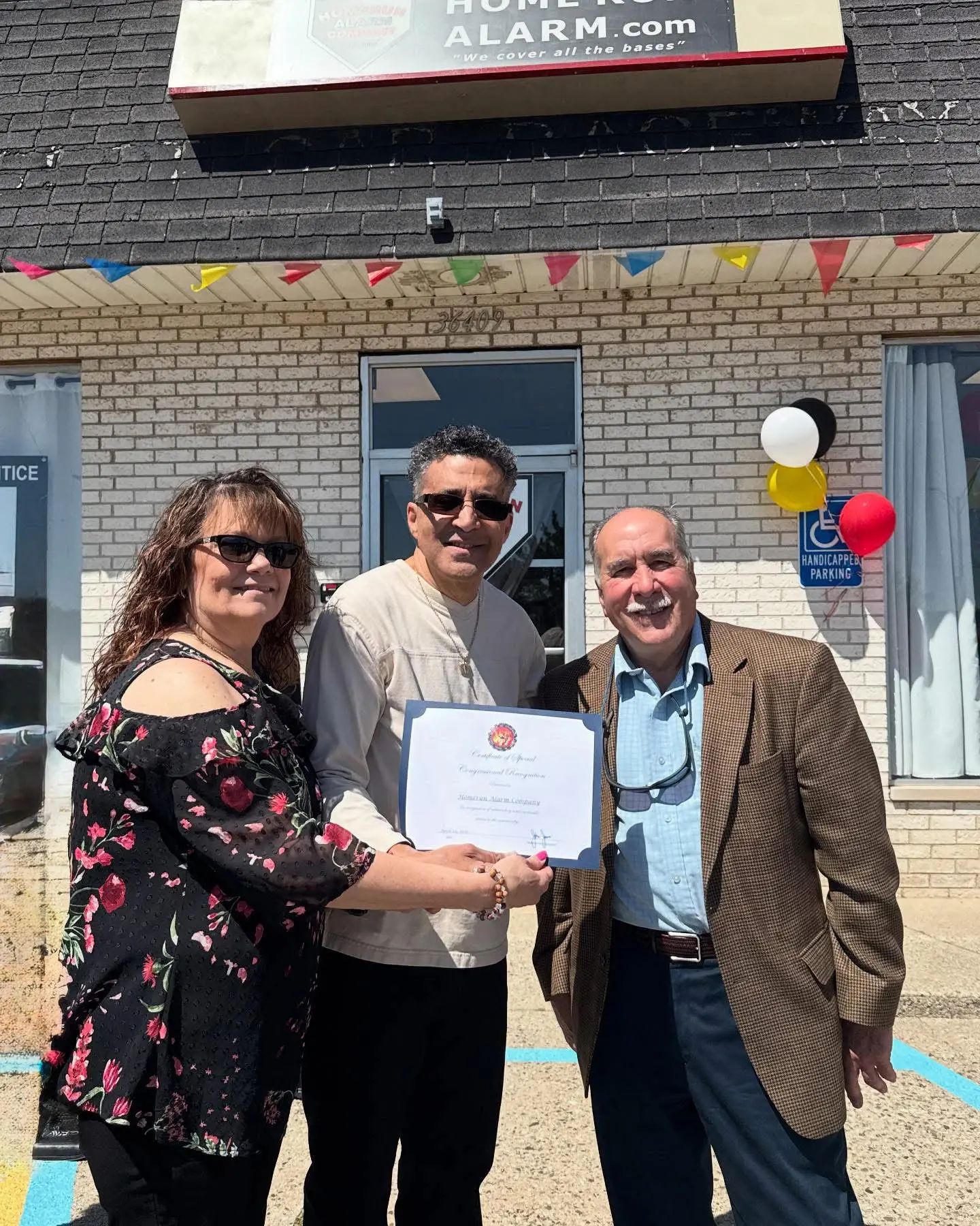CONGRESSIONAL CERTIFICATE RECEIVE Greg and Michele Diloné receiving Certificate of Special Congressional Recognition from District Director Phil Rode